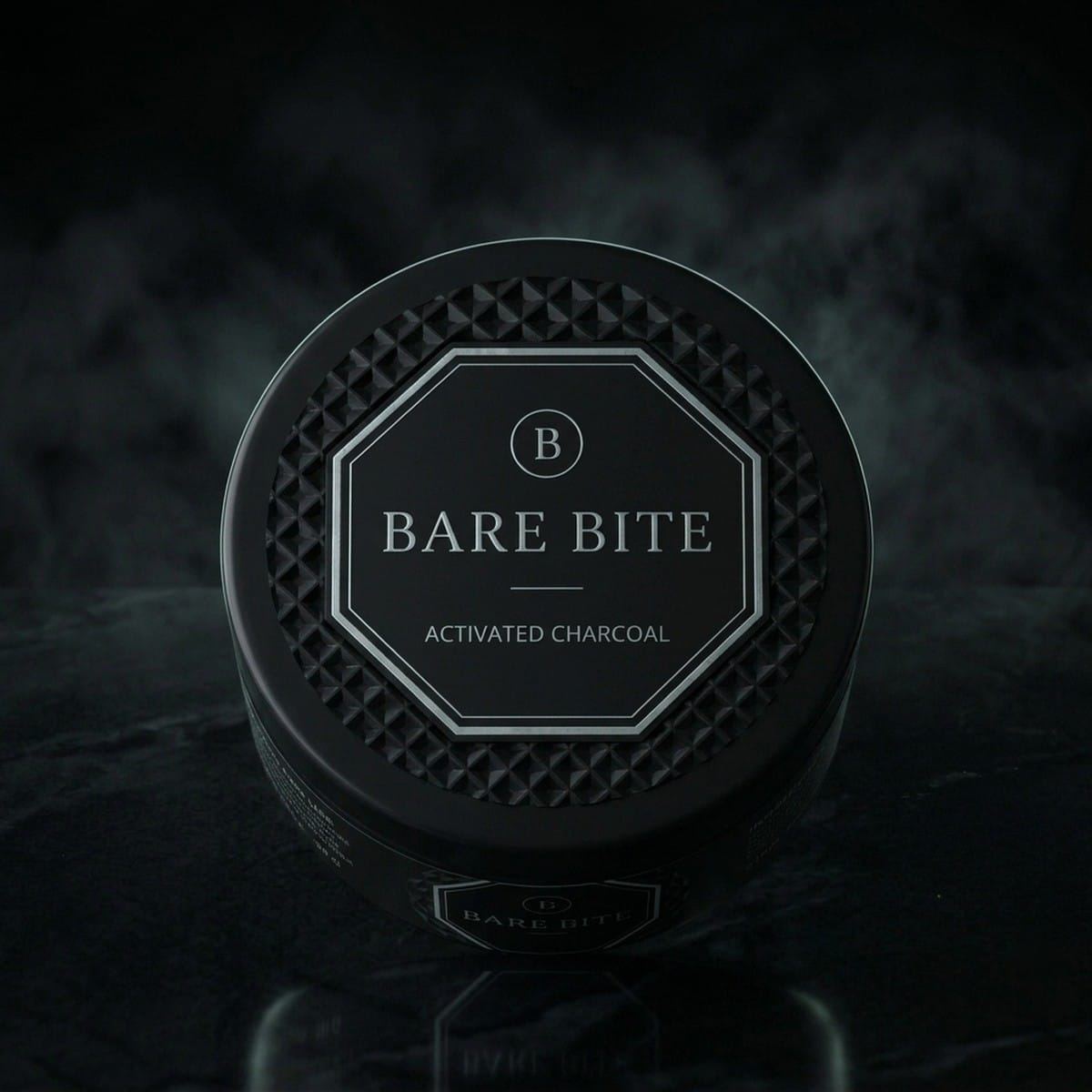 Top of the BARE BITE jar lid with faceted diamond texture and mint octagon logo